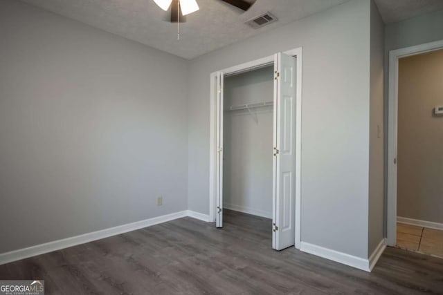 100 Downing Way Unit E, Athens, GA 30606 - unfurnished bedroom with ceiling fan, a closet, dark hardwood / wood-style flooring, and a textured ceiling