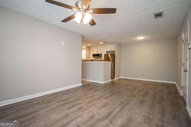 100 Downing Way Unit E, Athens, GA 30606 - unfurnished living room featuring ceiling fan, hardwood / wood-style floors, and a textured ceiling