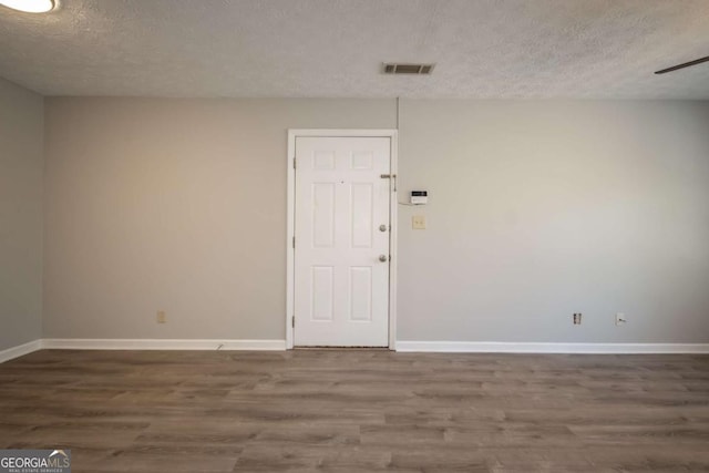 100 Downing Way Unit E, Athens, GA 30606 - empty room with hardwood / wood-style flooring and a textured ceiling