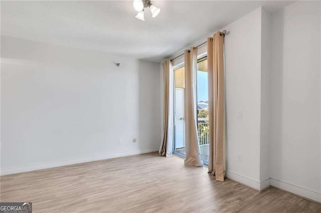 spare room with light hardwood / wood-style flooring