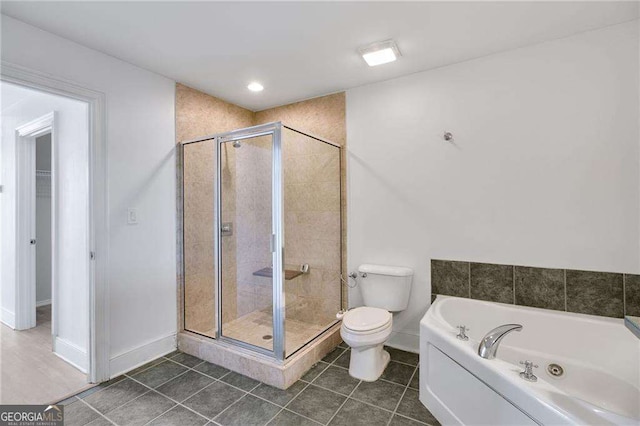 bathroom featuring toilet, plus walk in shower, and tile patterned flooring