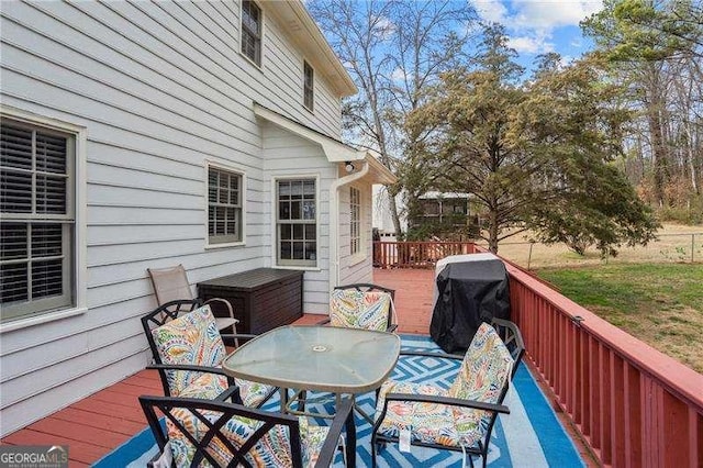 wooden terrace featuring a grill