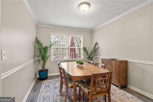 dining area with crown molding, wood-type flooring, and a textured ceiling