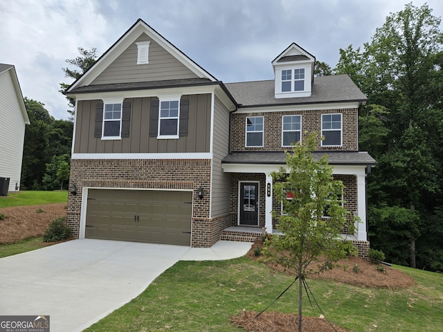508 Clayborne Way Unit 246A, Loganville, GA 30052 - view of front of property with an attached garage, brick siding, driveway, a front lawn, and board and batten siding