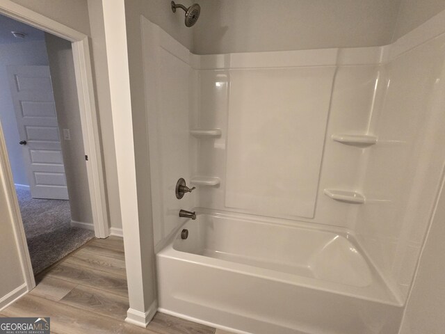 508 Clayborne Way Unit 246A, Loganville, GA 30052 - full bathroom with wood finished floors, washtub / shower combination, and baseboards