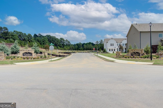 508 Clayborne Way Unit 246A, Loganville, GA 30052 - view of asphalt road featuring traffic signs, sidewalks, and curbs