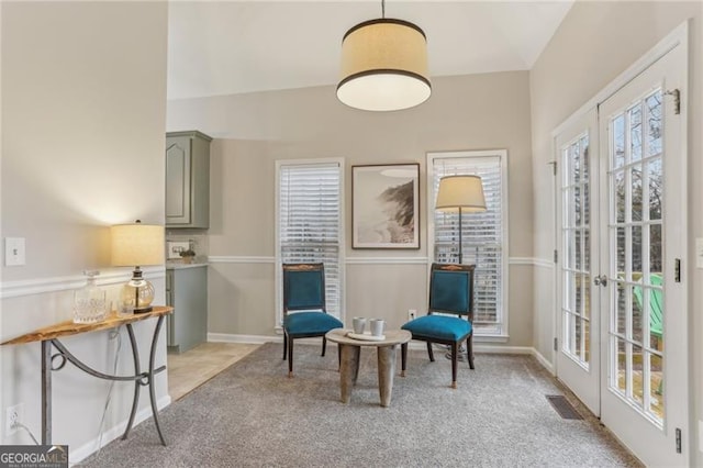 sitting room with light colored carpet and french doors