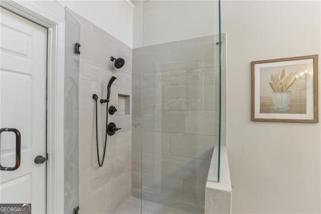 bathroom featuring a shower with shower door