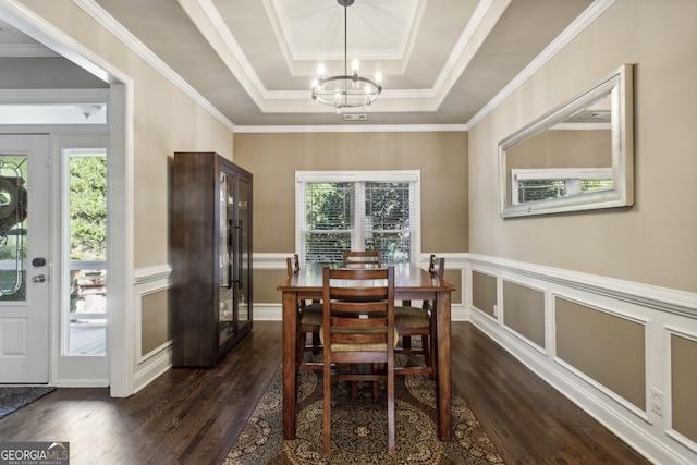 dining area featuring dark hardwood / wood-style flooring, a tray ceiling, and a healthy amount of sunlight