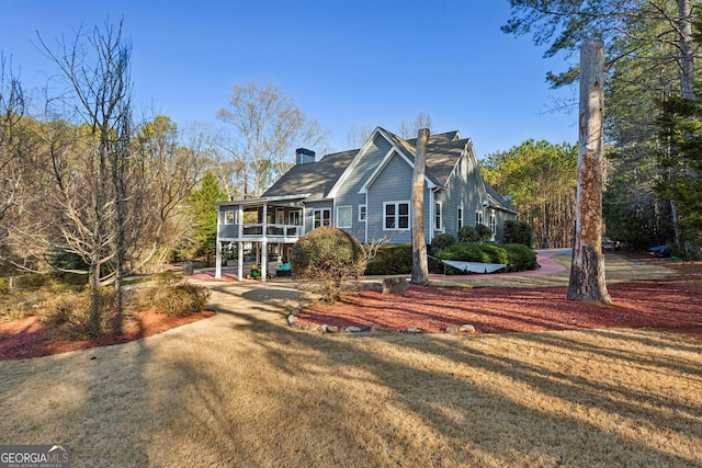 view of front of house featuring a front yard and a wooden deck