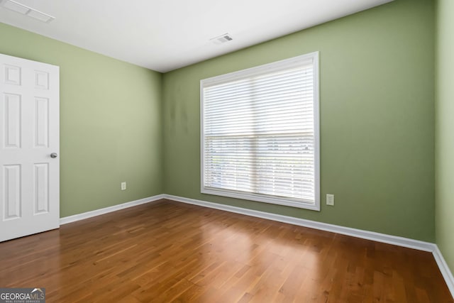 480 Glenns Farm Way, Grayson, GA 30017 - unfurnished room with healthy amount of natural light, baseboards, and wood finished floors
