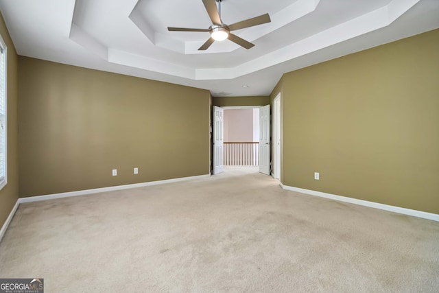480 Glenns Farm Way, Grayson, GA 30017 - spare room featuring a raised ceiling, a ceiling fan, light carpet, and baseboards