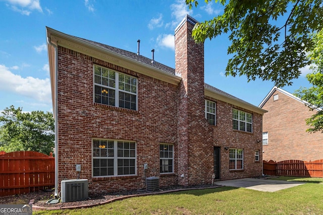 480 Glenns Farm Way, Grayson, GA 30017 - back of property featuring central AC, brick siding, a chimney, and a patio