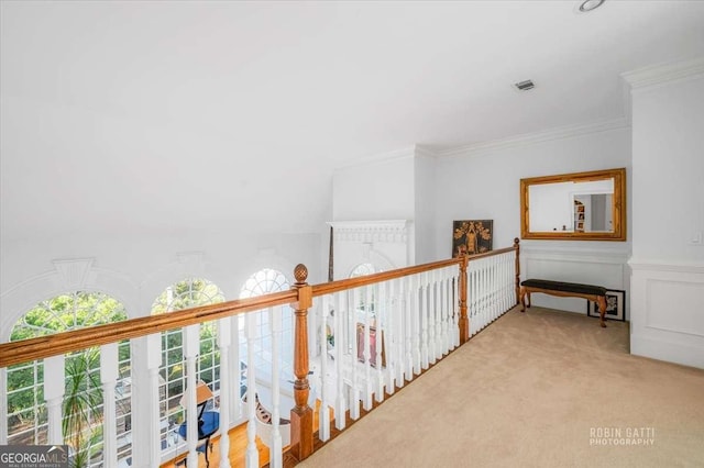 hallway featuring ornamental molding and light carpet