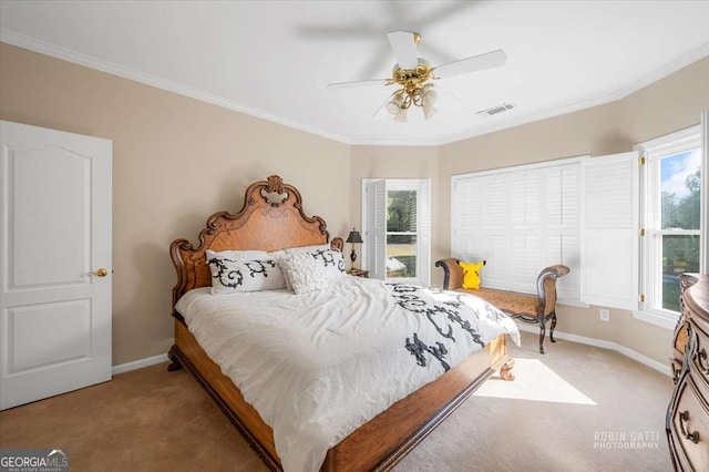 bedroom with crown molding, ceiling fan, and carpet