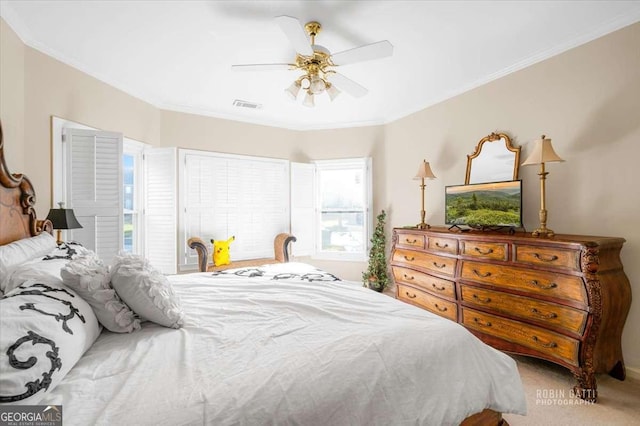 bedroom with crown molding, carpet flooring, and ceiling fan