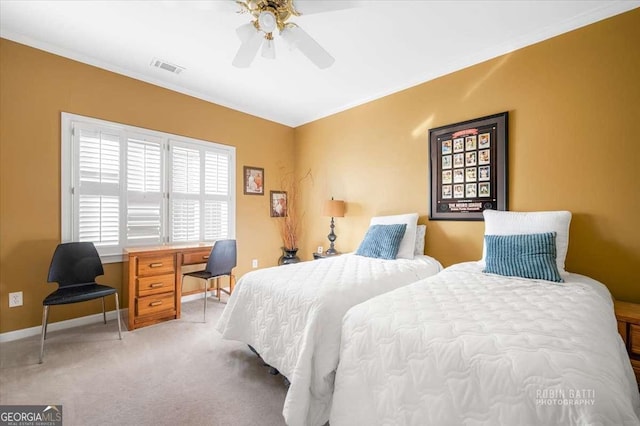 bedroom featuring ornamental molding, light colored carpet, and ceiling fan