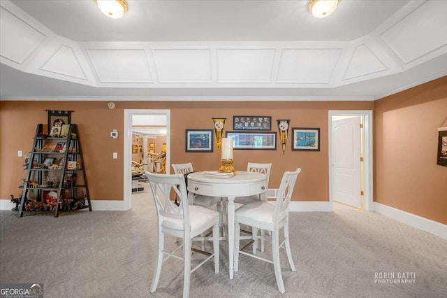 unfurnished dining area featuring crown molding and light carpet