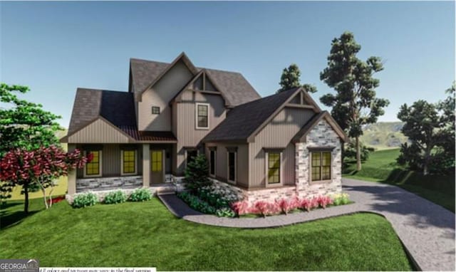 view of front of house with stone siding, driveway, and a front lawn