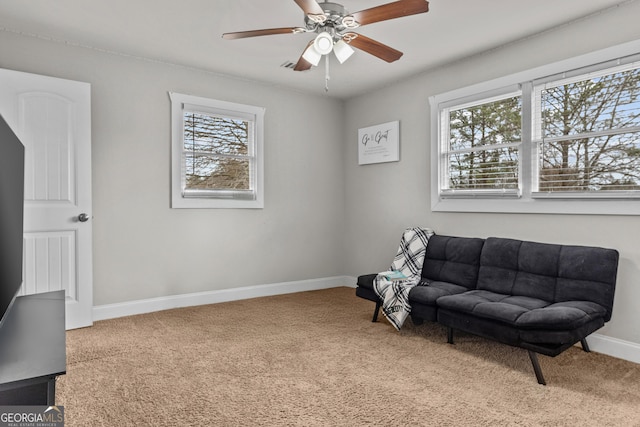 living area with carpet flooring and ceiling fan