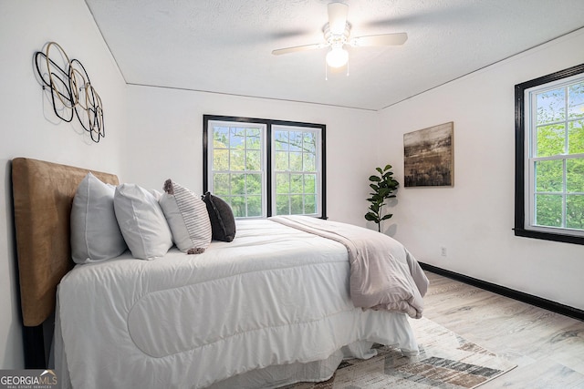 1490 Broad St NE, Conyers, GA 30012 - bedroom with wood finished floors, ceiling fan, and a textured ceiling