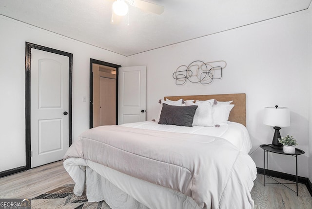 bedroom featuring baseboards, ceiling fan, and light wood finished floors