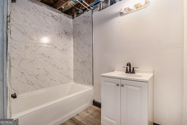 bathroom featuring shower / tub combination, wood finished floors, and vanity