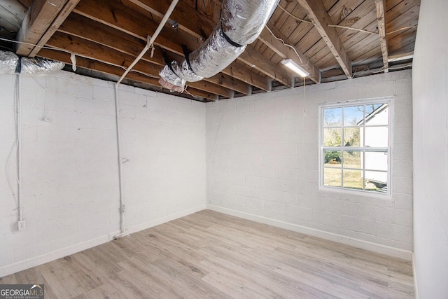 basement with light hardwood / wood-style flooring