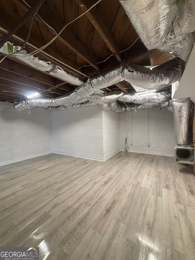 1490 Broad St NE, Conyers, GA 30012 - unfinished basement featuring light wood-style flooring and baseboards