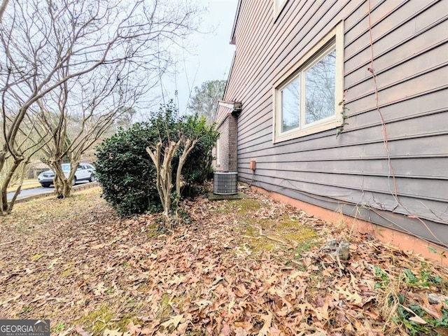 view of side of home featuring central AC unit