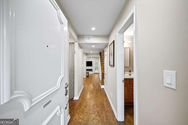 corridor with dark hardwood / wood-style flooring