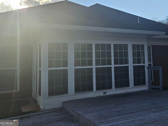 view of home's exterior with a wooden deck