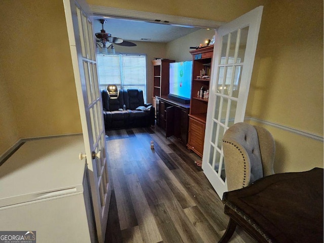 corridor with dark hardwood / wood-style flooring and french doors