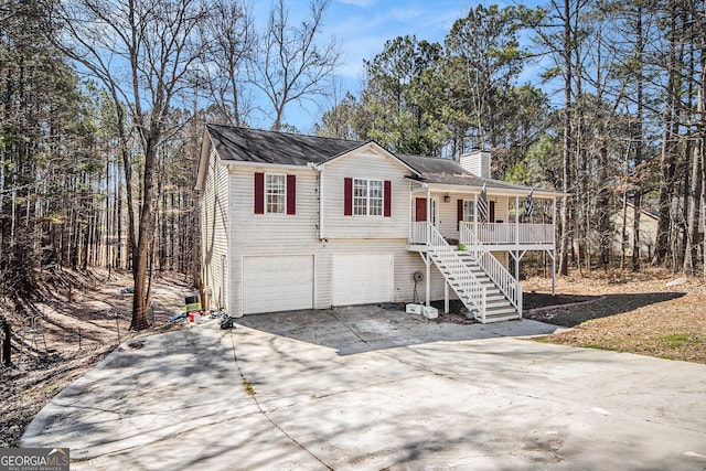 view of front facade featuring an attached garage, covered porch, driveway, stairway, and a chimney