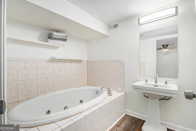 full bathroom featuring baseboards, visible vents, a ceiling fan, wood finished floors, and a whirlpool tub