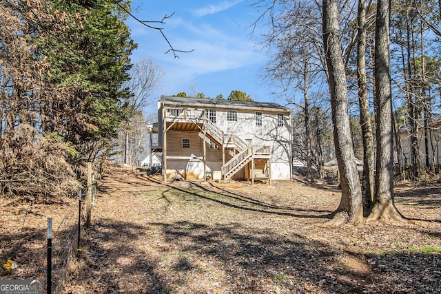 rear view of house with stairway and a deck