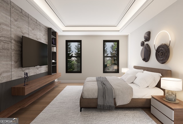 bedroom with a raised ceiling and hardwood / wood-style floors