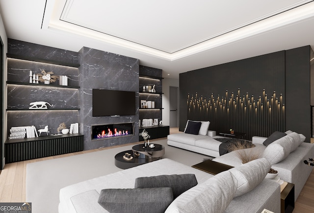 living room featuring a fireplace, a raised ceiling, and hardwood / wood-style floors