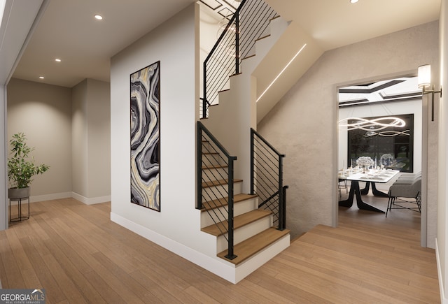 stairs featuring wood-type flooring