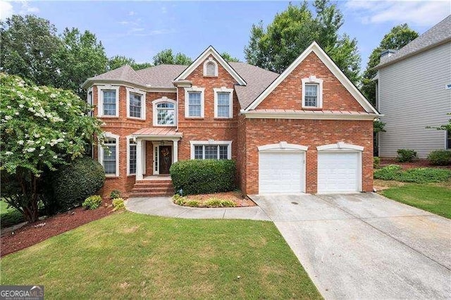 view of front of home featuring a garage and a front lawn