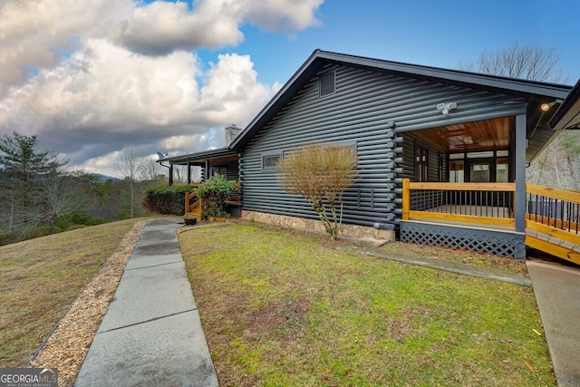 view of property exterior with covered porch and a lawn