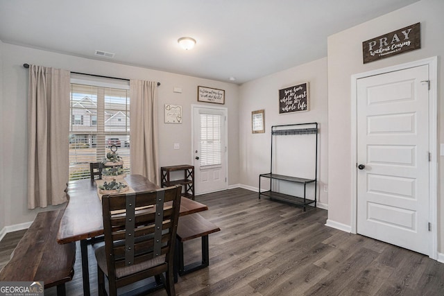 dining space featuring baseboards, visible vents, and dark wood-style flooring