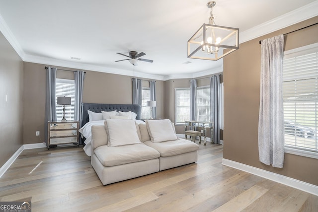 bedroom featuring light wood-style flooring, visible vents, ornamental molding, and baseboards