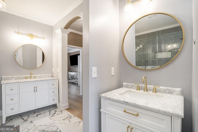 full bath featuring marble finish floor, two vanities, a sink, and crown molding