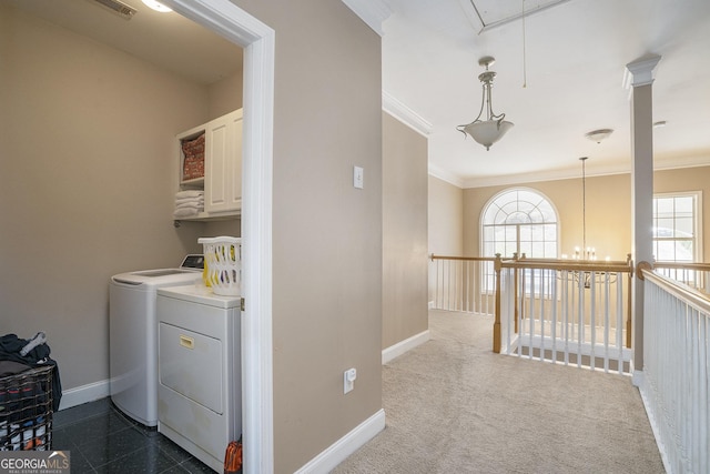 interior space featuring crown molding, cabinet space, attic access, washing machine and dryer, and baseboards