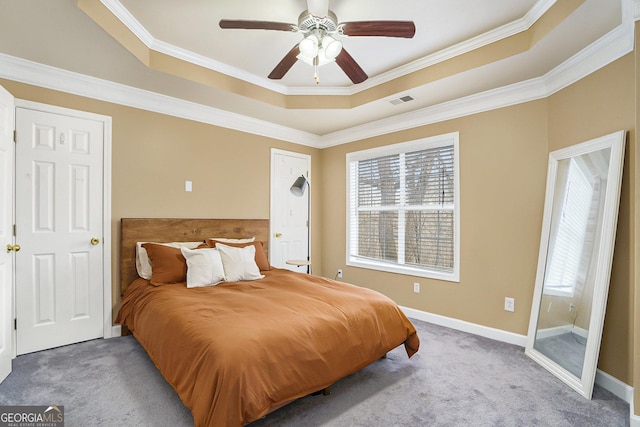 carpeted bedroom featuring multiple windows, a raised ceiling, and visible vents