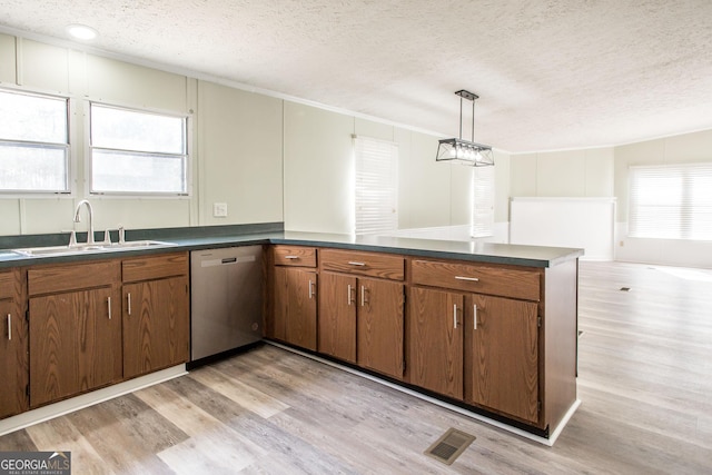 kitchen featuring sink, light hardwood / wood-style flooring, dishwasher, a textured ceiling, and decorative light fixtures