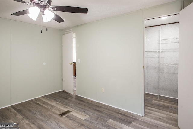 empty room with wood-type flooring and ceiling fan