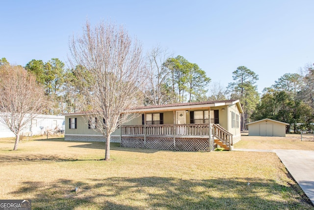 view of front facade with an outbuilding, a porch, a garage, and a front yard