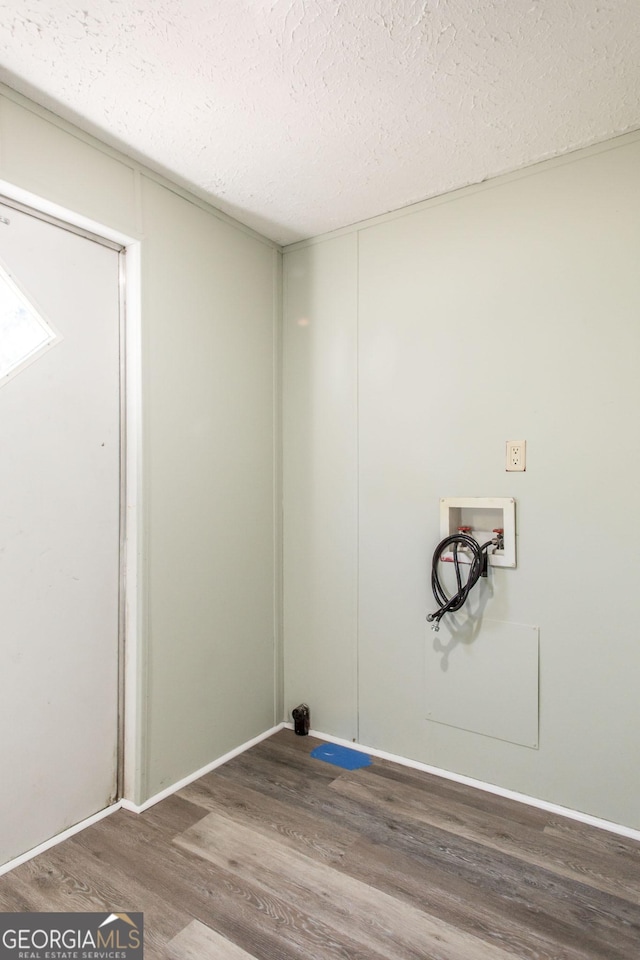 laundry area with washer hookup, hardwood / wood-style floors, and a textured ceiling